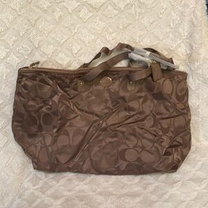 Dark brown Coach Extra Large Weekend tote with small medium cosmetic bag